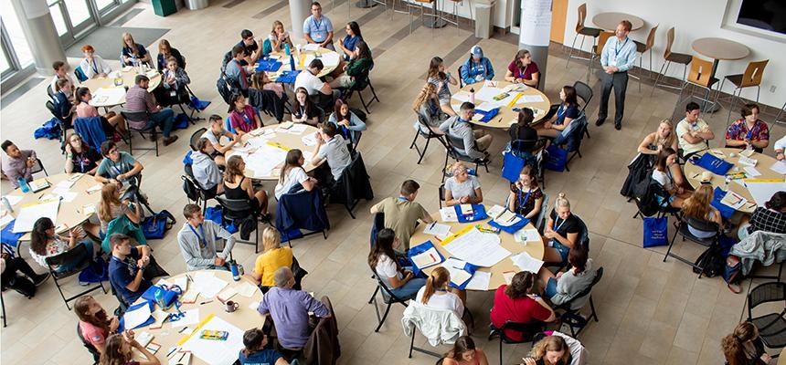 image of tables full of collaboration at Honors retreat